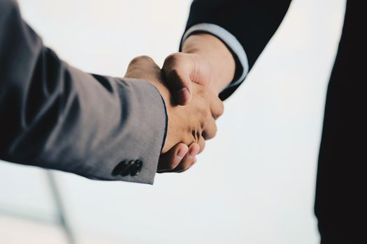 Close up of Business people shaking hands, finishing up meeting, business etiquette, congratulation, merger and acquisition concept