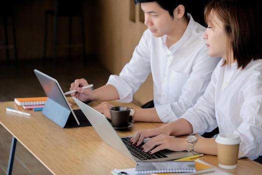 Business team brainstorming and discussing financial report graph with laptop computer. Teamwork meeting working concept.