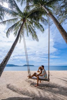 couple on the beach in Phuket relaxing on a beach chair, tropical beach in Phuket Thailand. Nakalay beach