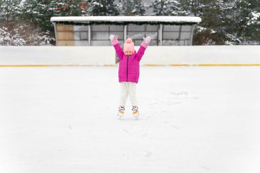 happy child at winter outdoor ice rink