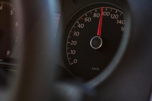 high speed on speedometer in automobile on dark background