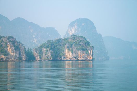 island and rocks in thailand near the blue sea in fog