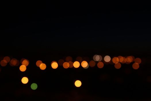 Night lights bokeh background. City flashlights defocused