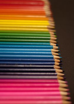 colorful rainbow pencils row gradient on black background