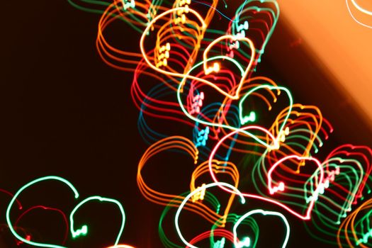 blurred abstract christmas lights lines on black background