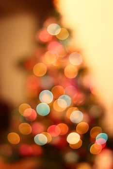 Christmas lights on xmas tree defocused. Holiday bokeh background