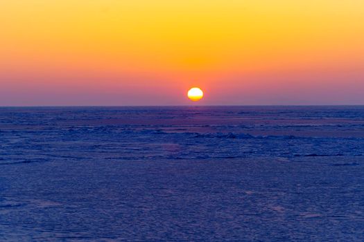 Beautiful sunset over the icy surface of the sea