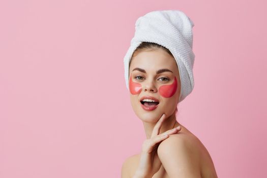 beautiful woman pink patches on the face with a towel on the head isolated background. High quality photo