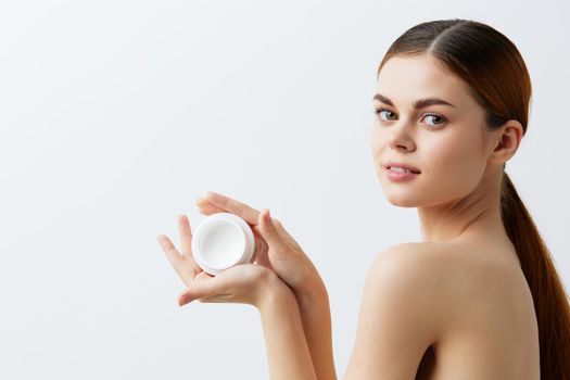 portrait woman body cream posing clean skin care attractive look light background. High quality photo