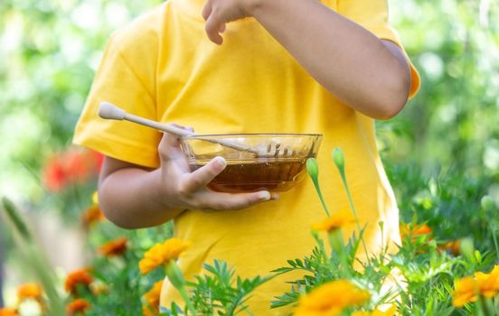 child eats honey in the garden. Nature. selective focus