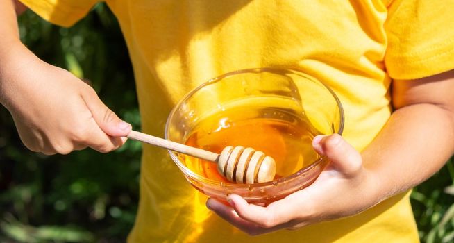 child eats honey in the garden. Nature. selective focus