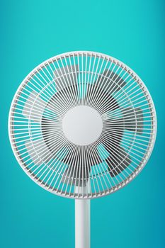 A high-tech white electric fan with a modern design for cooling the room on a blue background. Minimalistic style