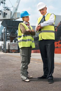 Two engineers discussing planning on a site while in the shipyard