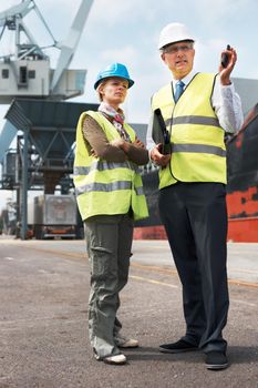 Two engineers discussing planning on a site while in the shipyard