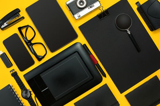 Workplace with office items and business elements on a yellow background. Concept for branding. Top view. Copy space. Still life