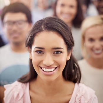 Cropped portrait of a smiling businesswoman amongst her coworkers