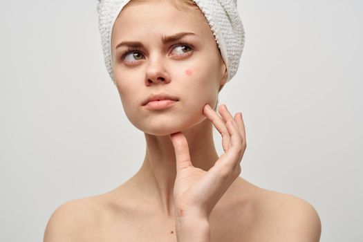 pretty woman with a towel on my head dermatology isolated background. High quality photo
