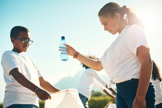 Shot of a group of teenagers picking up litter summer camp