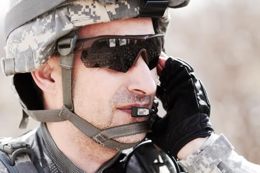 Closeup profile of a soldier communicating on his headset