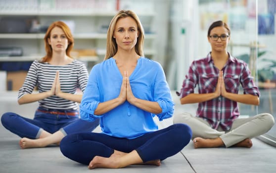 Group of attractive females doing some yoga indoors