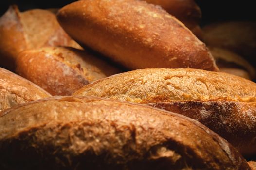 Lots of French bread rolls. Freshly baked French rolls are delicious. Close-up.