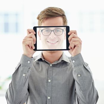 A young man holding a digital tablet with a transparent screen in front of his face