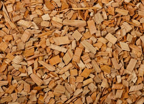 Close up background pattern of hardwood alder chips for food smoking and cooking, elevated top view, directly above