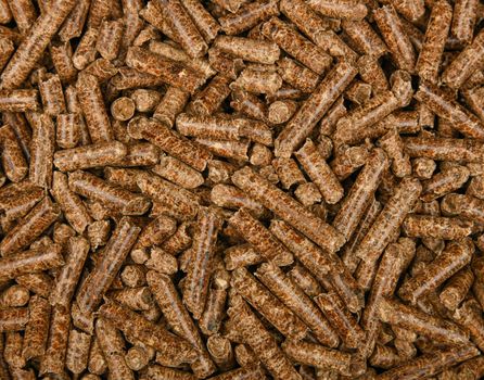 Close up background pattern of hardwood pellets for food smoking and cooking, elevated top view, directly above