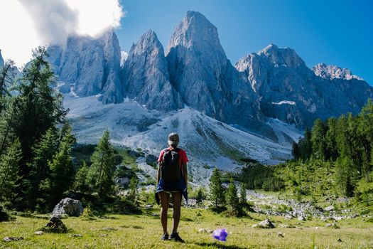 Geisler Alm, Dolomites Italy, hiking in the mountains of Val Di Funes in Italian Dolomites,Nature Park Geisler-Puez with Geisler Alm in South Tyrol. Italy Europe, woman hiking in moutains summer