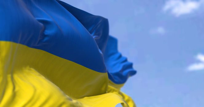 Detail of the national flag of Ukraine waving in the wind on a clear day. Democracy and politics. Eastern Europe country. Patriotism. Selective focus.