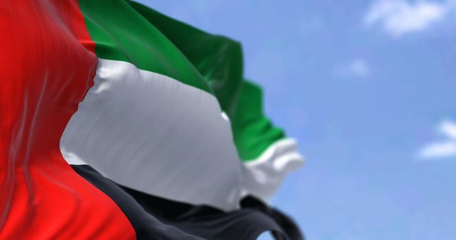 Detail of the national flag of United Arab Emirates waving in the wind on a clear day. Democracy and politics. Western Asia country. Patriotism. Selective focus.