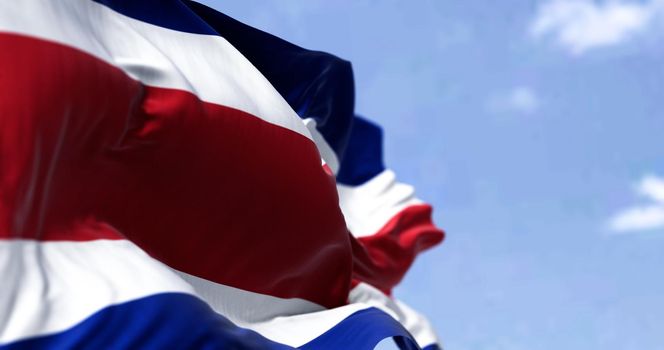 Detail of the national flag of Costa Rica waving in the wind on a clear day. Democracy and politics. Patriotism. Selective focus. Seamless Slow motion
