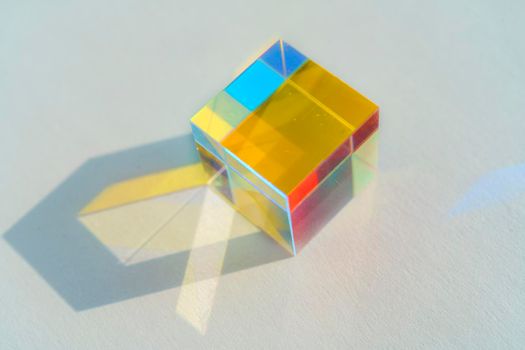 Cubic rainbow prism on a white background.