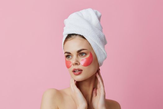woman pink patches on the face with a towel on the head close-up Lifestyle. High quality photo