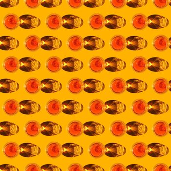 seamless pattern cognac glass with a hard shadow on a yellow background. High quality photo