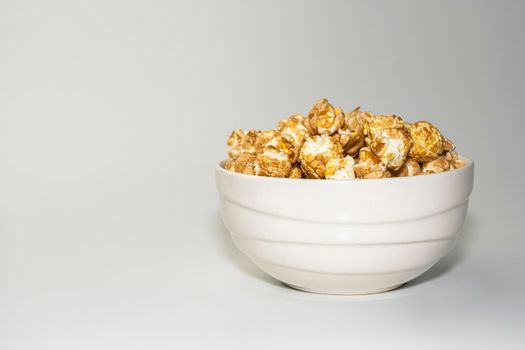 popcorn in a ceramic bowl on a gray background. High quality photo