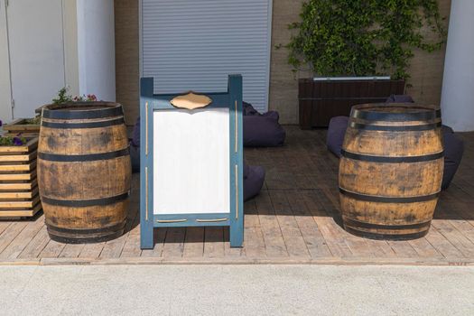 bulletin board for menus and advertisements and wooden barrels. High quality photo