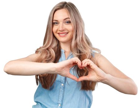 Young woman showing hand heart gesture isolated on white background