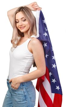 Portrait of a young smiling woman holding USA flag isolated on white background