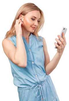 Portrait of a smiling casual woman holding smartphone over white background, close up