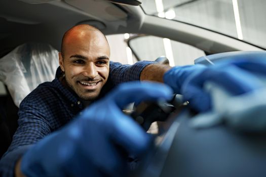 A man cleaning car interior, car detailing in Carwash service, close up