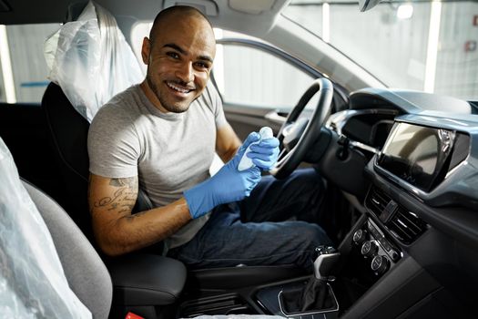 A man cleaning car interior, car detailing in Carwash service, close up