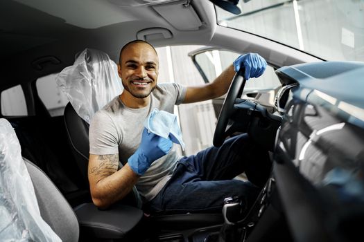 A man cleaning car interior, car detailing in Carwash service, close up