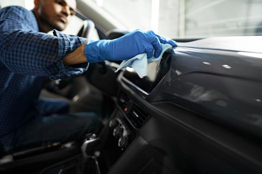 A man cleaning car interior, car detailing in Carwash service, close up