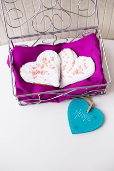 Cookies in the form of heart on a pink napkin inscription home.