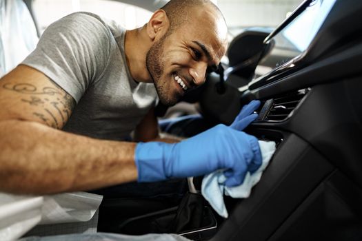 A man cleaning car interior, car detailing in Carwash service, close up