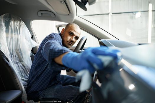 A man cleaning car interior, car detailing in Carwash service, close up