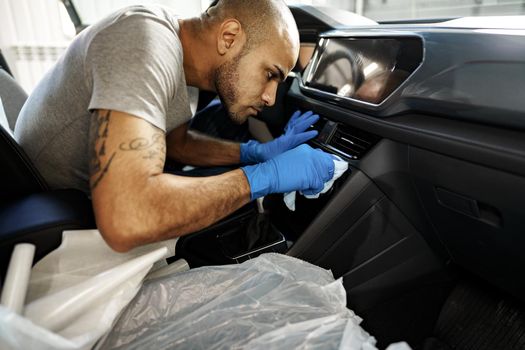 A man cleaning car interior, car detailing in Carwash service, close up
