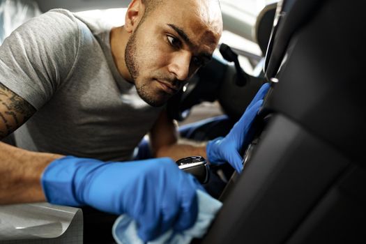 A man cleaning car interior, car detailing in Carwash service, close up