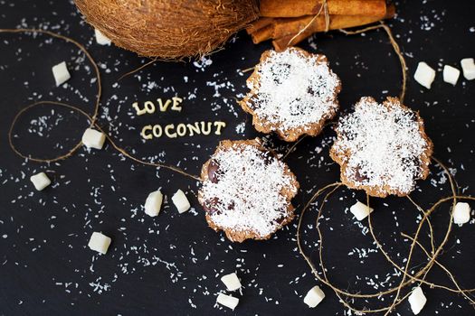 coconut muffins on a black background inscription love coconuts, close-up